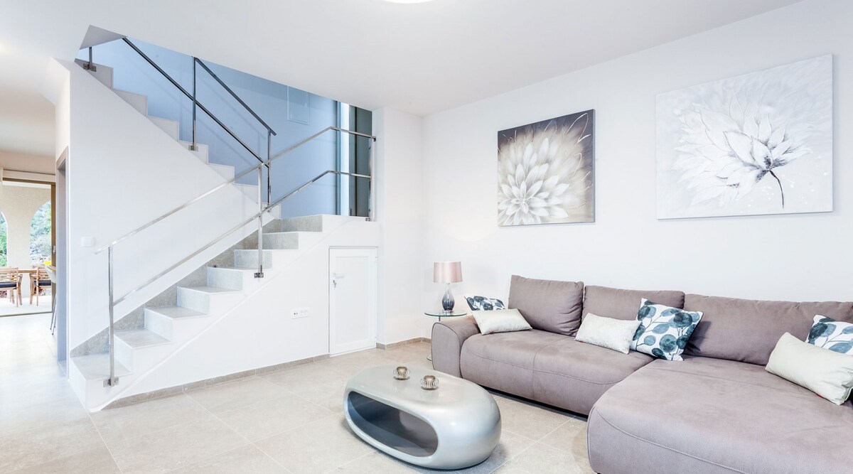 Inside Villa Belveder — Mediterranean living area in natural stone and wood with sea view over Mikulina Luka