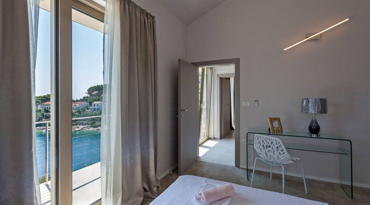Master bedroom at Villa Belveder with sea-view windows opening to the Adriatic, Vela Luka, Korčula